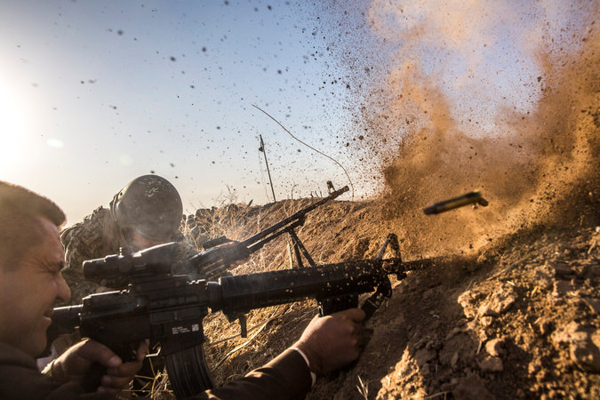 The battle for Mosul, Iraq began overnight, with enormous destruction expected as Iraqi forces try to oust the so-called Islamic State. Above: Kurdish peshmerga fighters take aim at ISIS. (Bryan Denton/The New York Times)