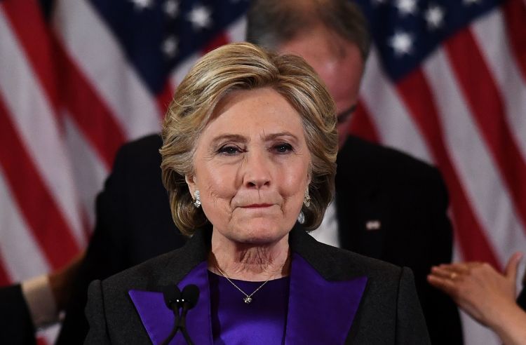 Hillary Rodham Clinton at her concession speech a few hours ago, with running mate Tim Kaine behind her. The defeat is painful, she said, but her supporters owe the U.S. President-Elect "an open mind and a chance to lead." (Jewel Samad/Agence France-Presse)